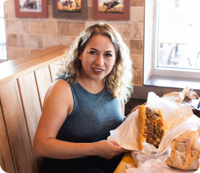 woman holding a beef sandwich